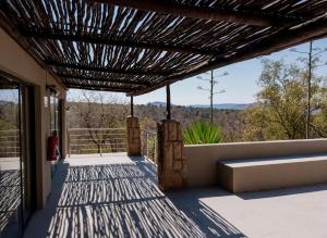 a view from the porch of a house with a pergola at Elements Private Golf Villa 295 in Warmbaths