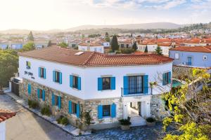 an aerial view of a white house with blue windows at Lyse Jülide Hotel in Çeşme