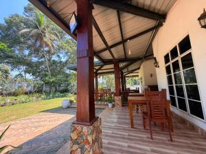 a patio with a table and chairs on a house at Singha Holiday Bungalow in Ibbagomuwa