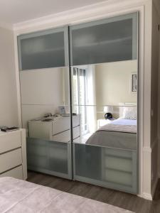 a bedroom with sliding glass doors leading to a bed at Modern room (with deck) in Povoação