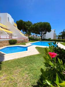 a swimming pool in the yard of a house at Vilamoura Condo facing the pool by Algarve Dream Holidays in Quarteira