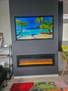 a fireplace in a living room with a tv above it at Ruth's Rest Shropshire Country Retreat with private Hot Tub & Views countryside in Shrewsbury
