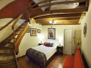 a bedroom with a large bed and a staircase at Tandapata Boutique Hotel in Cusco
