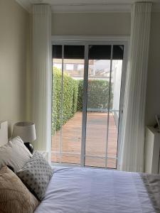 a bedroom with a bed and a sliding glass door at Modern room (with deck) in Povoação +9 photos