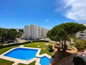 an image of a swimming pool in a park at Vilamoura Condo facing the pool by Algarve Dream Holidays in Quarteira