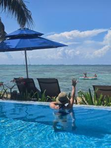 a person in a swimming pool next to the ocean at Secret Spot Lagoon Dream in Moorea +67 photos