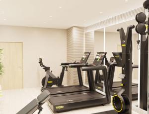 a gym with three tread machines in a room at Knowsley Inn & Lounge in Knowsley