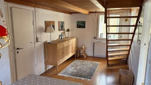 a room with a staircase and a dresser in a room at Válur Cozy Cottage in Válur