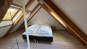 a bedroom with a bed in a attic at Válur Cozy Cottage in Válur