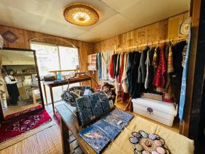 a child sitting on a couch in a room with a closet at Family Homestay Shirokuro Guesthouse in Nakakiri