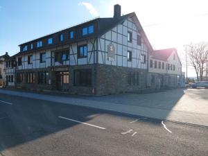 a large building on the side of a street at DER Hirsch Hotel in Monschau