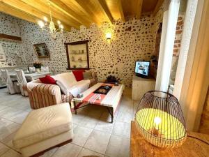 a living room with a couch and a table at Gîte des graverots in Aire-sur-lʼAdour