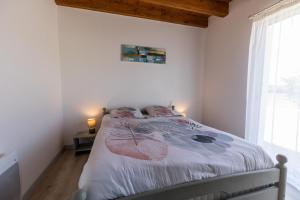 a bedroom with a bed with two pillows on it at Juine in Fargues