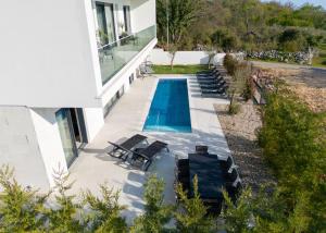 an aerial view of a house with a swimming pool at Villa Sensei in Linardići