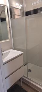 a white bathroom with a sink and a shower at Mimilou Eleuthera 300 m centre naturiste in Cap d'Agde +15 photos