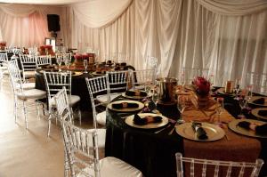 a banquet hall with tables and chairs with food on them at Lodge Linga Longa in Queenstown
