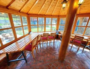a dining room with a large wooden table and chairs at Bosnian Villa & Chalet in Hadžići