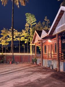 a house with a lit up facade at night at VIVIPRA Habitat, Coorg in Madikeri