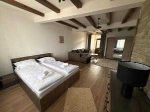 a bedroom with a bed and a living room at Панорамна гледка in Leshten