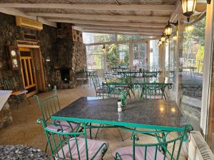 a patio with tables and chairs in a restaurant at Folwark Historic Hotel in Warsaw