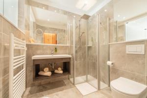 a bathroom with a shower and a sink and a toilet at APIPURA hotel rinner in Soprabolzano +27 photos