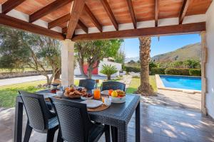 a table with food on it on a patio at Villa Can Deyá in Port de Pollensa