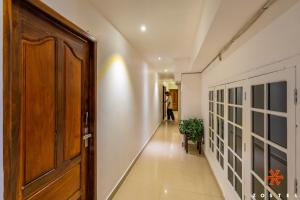 a hallway with a wooden door in a building at Zostel Munnar in Devikolam +39 photos