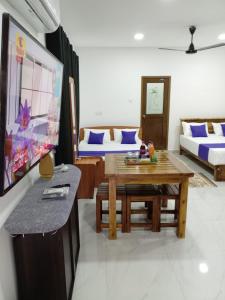 a living room with a table and a couch at Nil Manel Tourist in Anuradhapura +39 photos