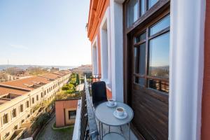 a balcony with a table and a view of a city at King Suite Hotel Beşiktaş in Istanbul