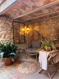 a patio with a wicker chair and a table at ruralhome sanroque in Altura