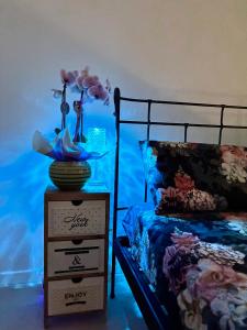 a bedroom with a bed and a dresser with a vase on it at 33 Joy Dreams in Sandra +2 photos