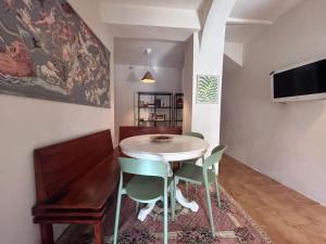 a dining room with a white table and chairs at Casa Laura in Modigliana