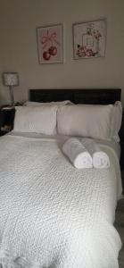 a bed with two towels on top of it at Banbury causeway in Banbury