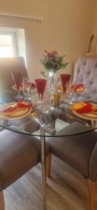 a glass table with wine glasses on top of it at Banbury causeway in Banbury