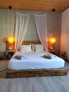 a bedroom with a large bed with two pillows at Kefalonia Olive House private pool in Xi +47 photos