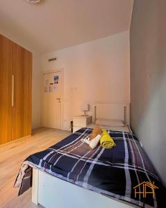 a bedroom with a bed with a blue and yellow blanket at CarloAlberto23- Rooms by Homes in Ancona in Ancona