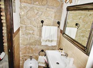 a bathroom with a sink and a toilet and a mirror at Antico Casale Fabrizi in Velletri
