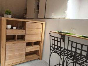 a kitchen with a counter and a wooden shelf at Studio gare et commerces sur place in Nogent-lʼArtaud