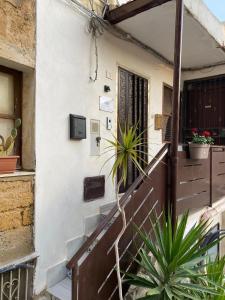 a house with stairs and plants in front of it at ANTICO VICOLO in Agrigento
