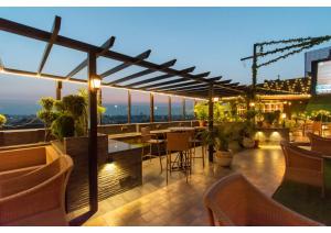 a rooftop patio with a table and chairs at The Grand Ambassador in Phagwāra