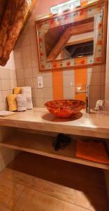 a bathroom counter with a bowl on a sink at Chambres d'hôtes Les Violles in Chirac +30 photos