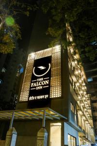 a sign for the falcon firm on the side of a building at The Falcon Inn - Clare Road in Mumbai