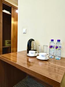 a table with two cups and two bottles of water at Grand Hotel Eurasia in Almaty