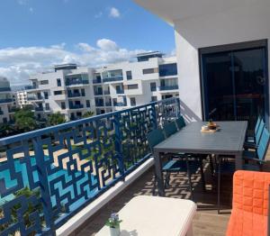 a balcony with a table and chairs on a building at Costa Mar, Costa 2 in Martil