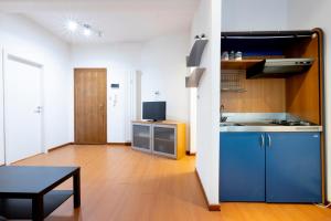 a kitchen with a blue refrigerator and a table at Pescara Centro sul Mare in Pescara +26 photos