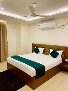 a bedroom with a large bed with green and white pillows at Hotel Ananta in Sasarām +56 photos