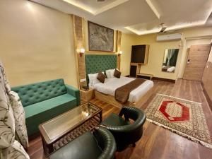 a hotel room with a bed and a couch at Krimzon Manor in Srinagar