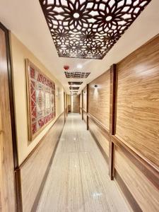 a long hallway with wooden floors and a ceiling at Krimzon Manor in Srinagar