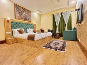 a bedroom with a bed and a television in it at Krimzon Manor in Srinagar