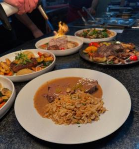 a table topped with plates of food and bowls of food at Rhein Hotel Bacharach und Stübers Restaurant in Bacharach +20 photos